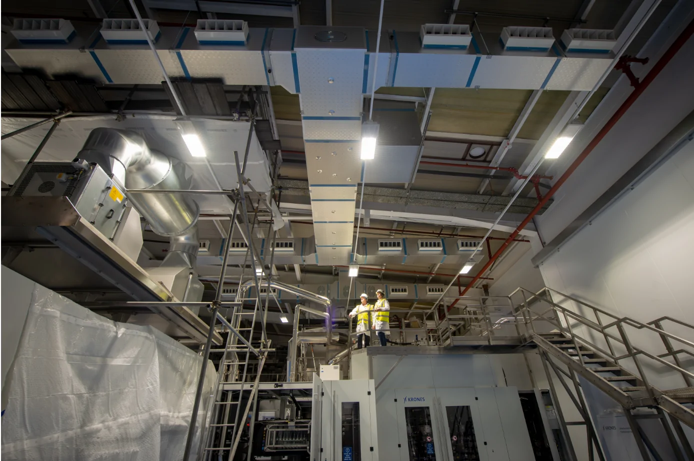 Plant room interior with packaged plant, large rectangular ductwork and insulated pipework.